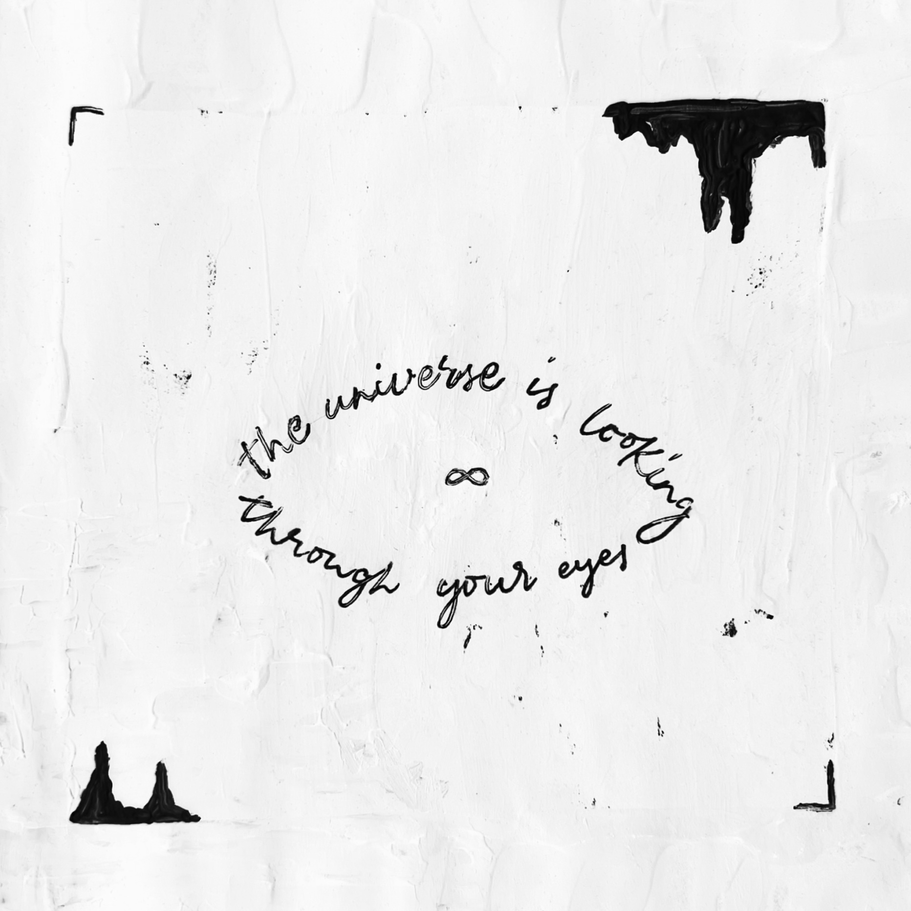 Circular hand-lettered quote reading the universe is looking through your eyes with an infinity symbol on textured white paper