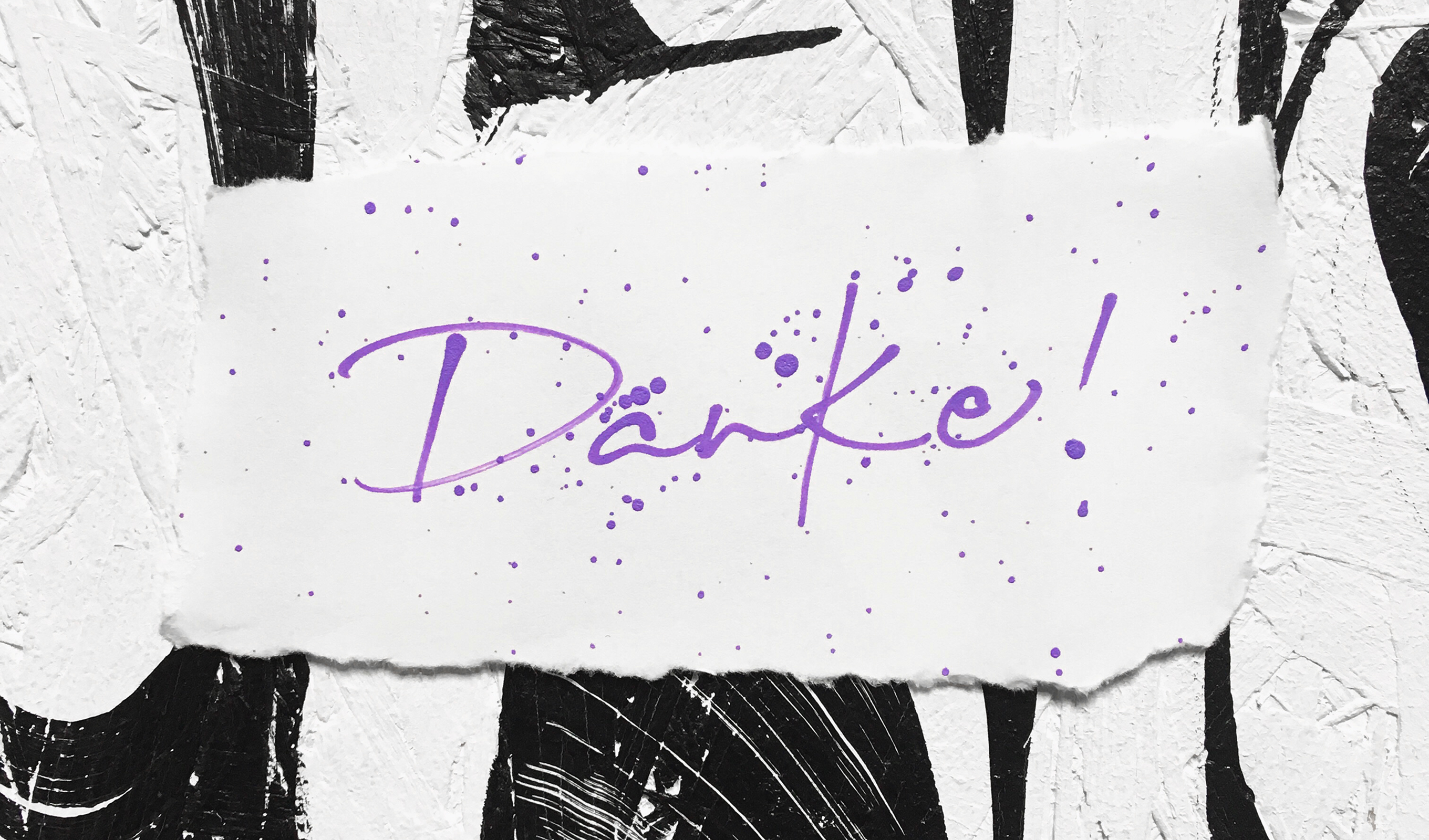Calligraphy artwork — purple Danke! brush lettering on torn paper